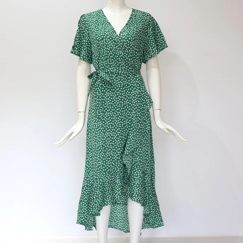 Green dress with white polka dots on a mannequin against a white background