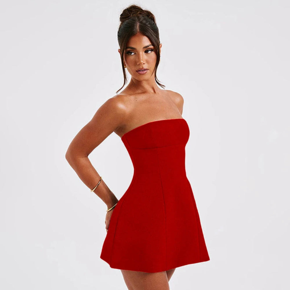 Woman wearing a strapless red dress on a white background