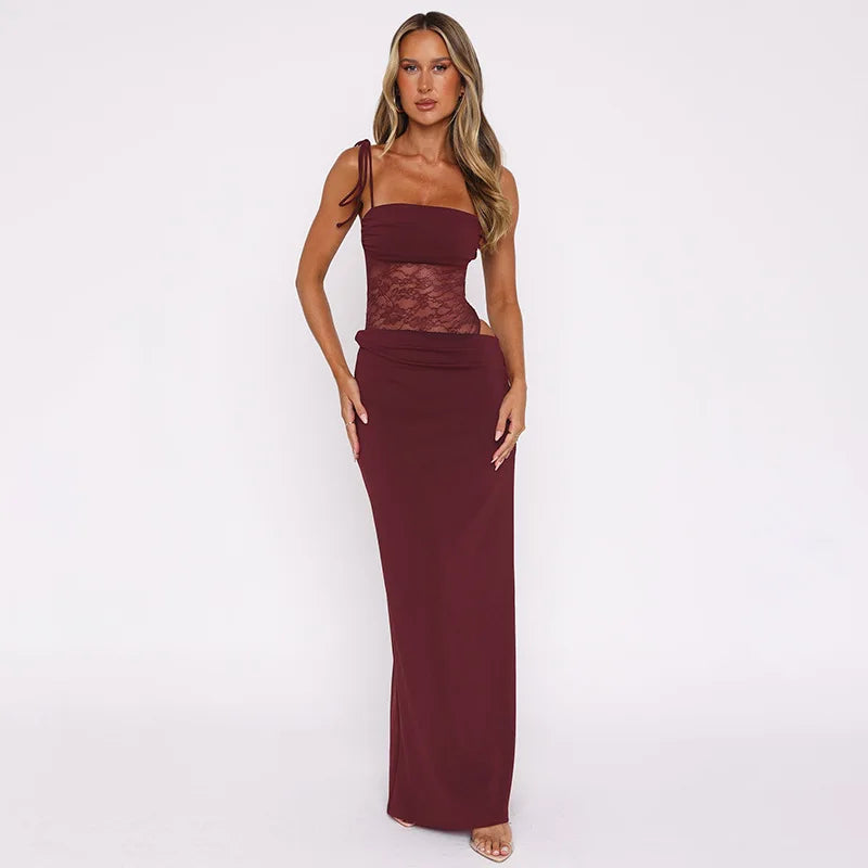 Woman wearing a burgundy dress with lace detailing on a white background